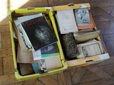 a yellow box filled with books on a wooden floor