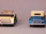 several toy trucks are lined up in a row on a gray surface