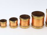 several different types of copper pipes are lined up on a white surface