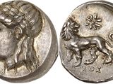 une pièce d'argent sur laquelle figurent une femme et un lion