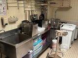 a kitchen with a sink and a stove in it