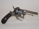 an old revolver with a black handle on a white surface