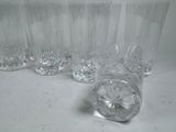 six glasses sitting on a table next to each other