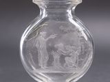 a glass vase with a picture of a man and a woman inside of it