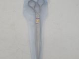 a pair of scissors in a plastic bag on a table