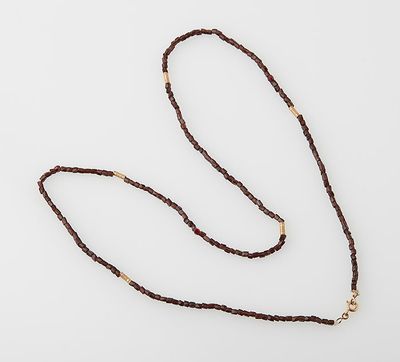 a close up of a long brown rope with a gold clasp