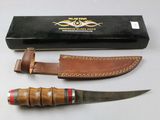 a knife that is sitting next to a box