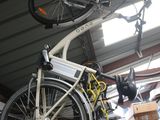 a bike that is hanging from the ceiling in a garage