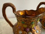 a gold vase with flowers on it on a table