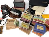 many different types of cameras and books on the table