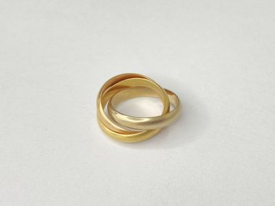 a close up of a gold ring on a white surface