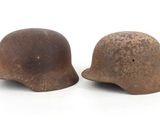 pair of old rusty helmets on white background with copy space for text