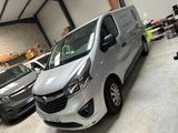 a silver van parked in a garage with other cars