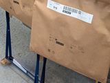 two boxes that are sitting on a carton on the ground