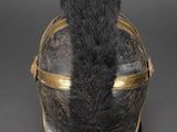 an old helmet with a furry tail sitting on top of a black surface
