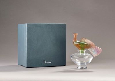 a small glass vase with a bird inside of it