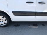 a small white van parked on the side of the road