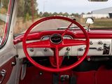 a red and white car with a red steering wheel