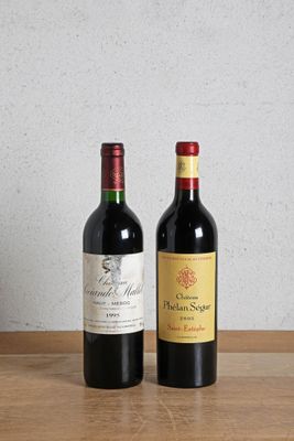 two bottles of wine sitting on top of a wooden table