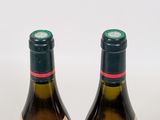 two bottles of wine sitting next to each other on a table