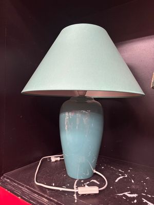 a blue lamp that is on top of a shelf