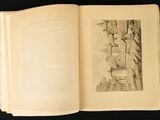 an open book with a drawing of a castle on it
