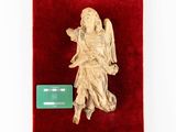 an image of a statue of an angel on a red velvet case