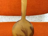 a vase that is sitting on a chair with a orange background