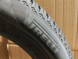 the tire of a bicycle is sitting on the floor next to a cardboard box