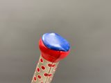 a red, white, and blue object in the shape of a toothbrush