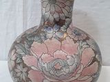 a vase that is sitting on a table with a white background