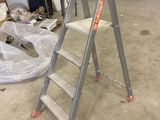 a ladder that is sitting in the middle of a room