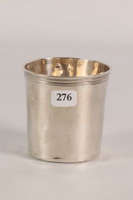 a silver cup with a number on it sitting on a table