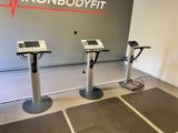 three tread machines in a room with a wall with the words ronbodyte on it