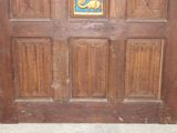 a wooden door with a blue and yellow emblem on it