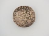 an old silver coin on a white surface with a white background