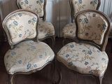 four chairs that are sitting on a wooden floor