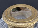 a glass jar with a gold lid on a table