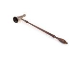 an old metal pipe with a wooden handle sitting on a white surface