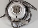 a metal object with a cord attached to it