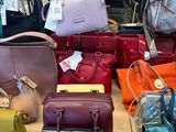 a lot of purses that are on display in a store