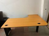 a wooden desk with two holes in the middle of it