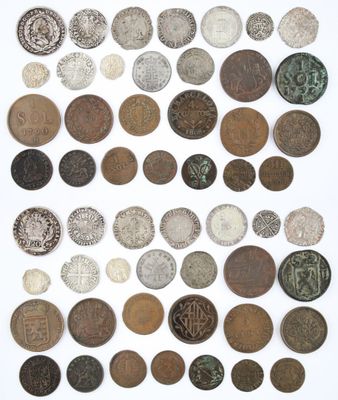 a group of old coins on a white surface