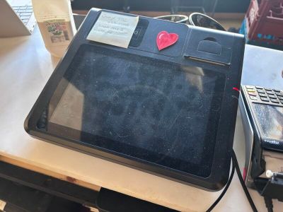 a laptop computer sitting on a desk with a heart sticker on the screen