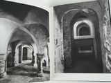 an open book with a black and white photo of a hallway