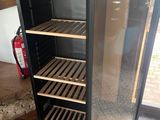 an image of a glass door refrigerator in a kitchen