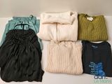many different types of clothes laid out on a table