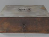 an old metal box with a handle on it