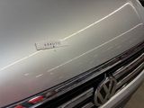 a close up of a volkswagen logo on the front of a car