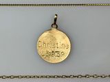 a close up of a gold coin on a gold chain